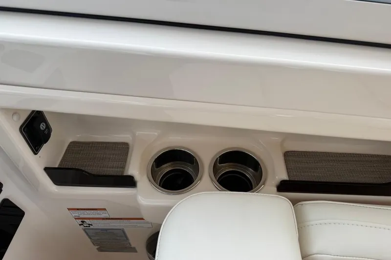 Slide: The Image of 2022 Grady-White Freedom 307 boat interior with cup holders and storage compartments. - 42