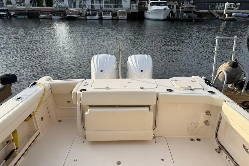 Slide: The Image of 2022 Grady-White Freedom 307 boat with dual engines docked at marina. - 9