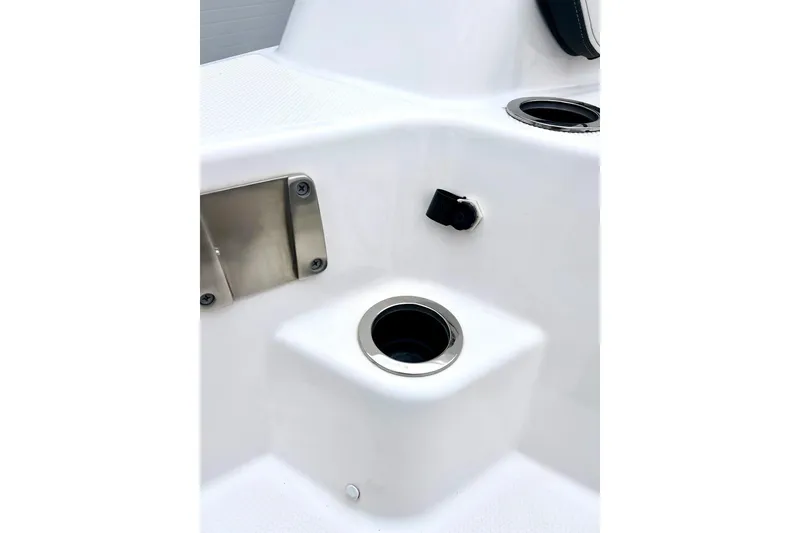 Slide: The Image of 2022 Yamaha Boats 255 FSH Sport H interior detail with cup holder and fittings. - 11