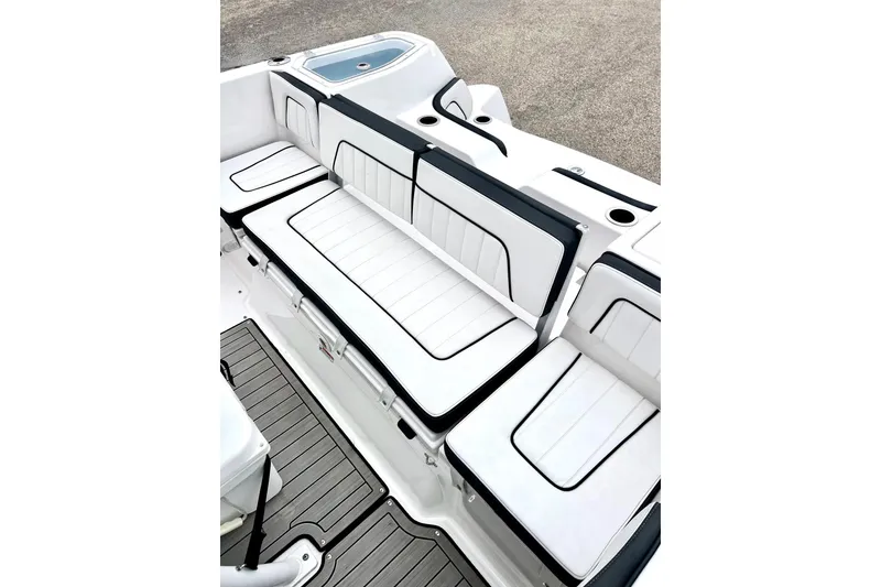 Slide: The Image of 2022 Yamaha Boats 255 FSH Sport H interior seating with sleek white and black design. - 21