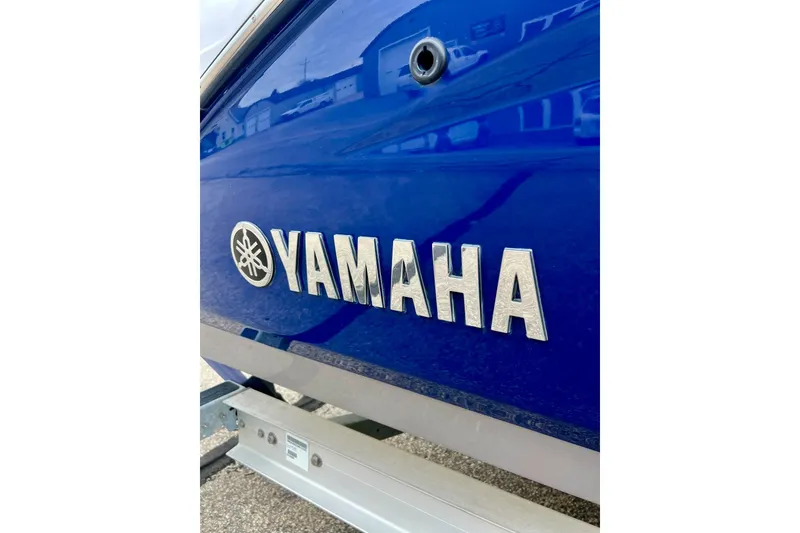 Slide: The Image of Blue 2022 Yamaha Boats 255 FSH Sport H with logo on side. - 3
