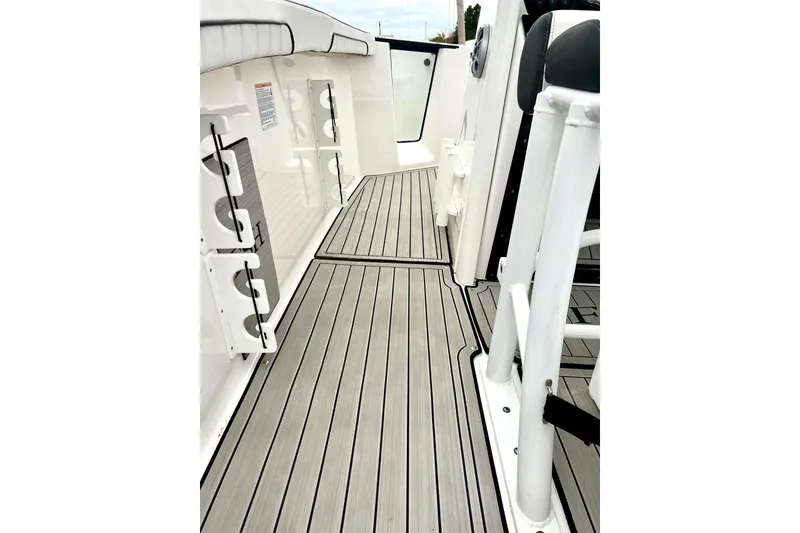 Slide: The Image of 2022 Yamaha Boats 255 FSH Sport H interior with sleek deck design and rod holders. - 37