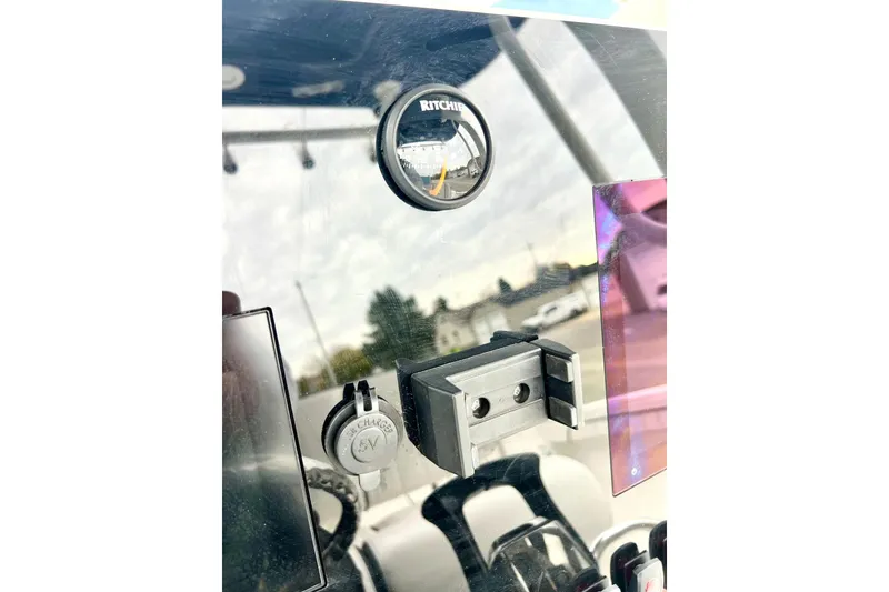 Slide: The Image of Dashboard of 2022 Yamaha Boats 255 FSH Sport H with compass and USB charger. - 42