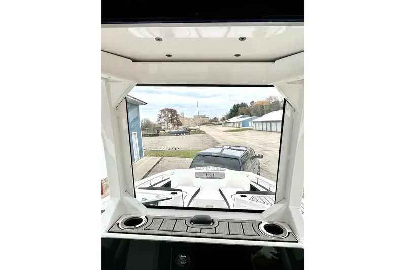 Slide: The Image of 2022 Yamaha Boats 255 FSH Sport H interior view, showcasing dashboard and windshield. - 45