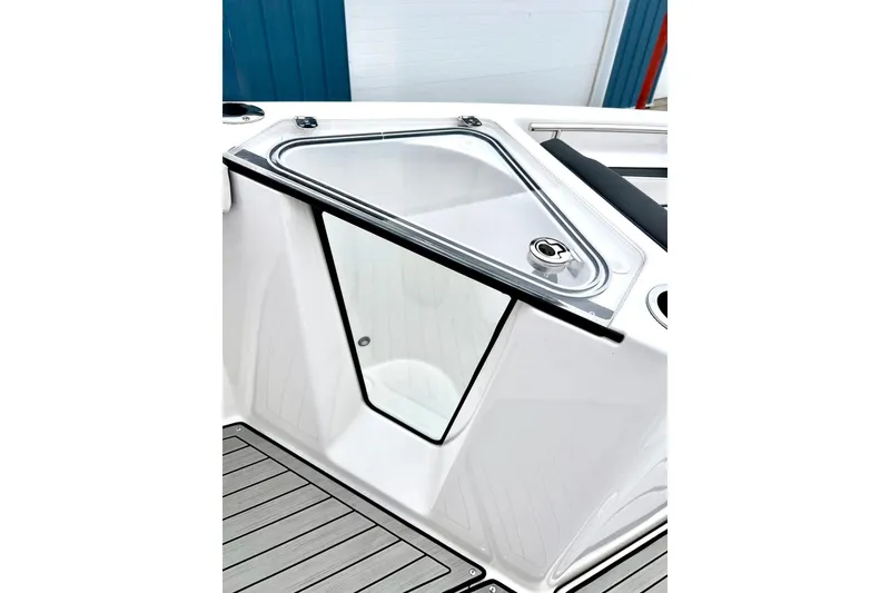 Slide: The Image of 2022 Yamaha Boats 255 FSH Sport H, sleek deck design with storage compartment. - 48