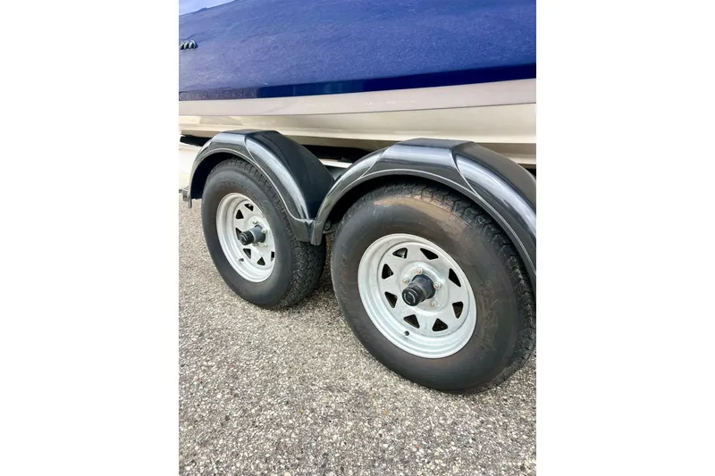 Slide: The Image of Trailer wheels of 2022 Yamaha Boats 255 FSH Sport H on pavement. - 5