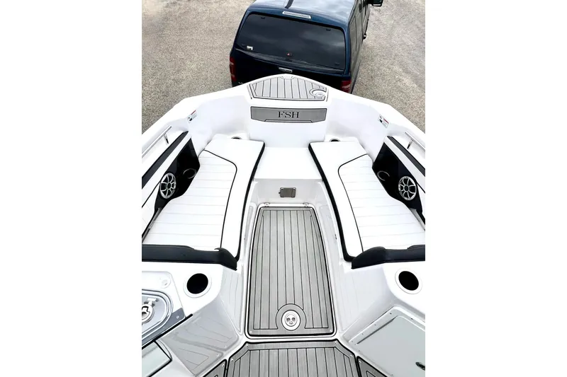 Slide: The Image of 2022 Yamaha Boats 255 FSH Sport H interior with white seating and sleek design. - 50