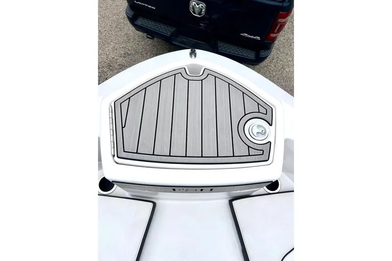 Slide: The Image of 2022 Yamaha Boats 255 FSH Sport H bow deck with sleek design and storage hatch. - 58