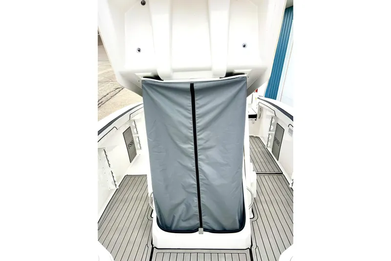 Slide: The Image of 2022 Yamaha Boats 255 FSH Sport H interior with gray cover and sleek deck design. - 63