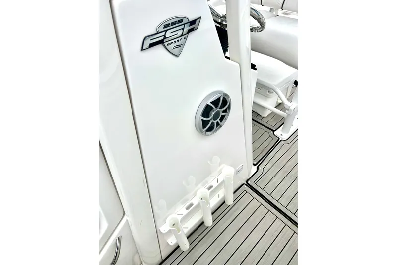 Slide: The Image of 2022 Yamaha Boats 255 FSH Sport H interior with speaker and rod holders. - 65