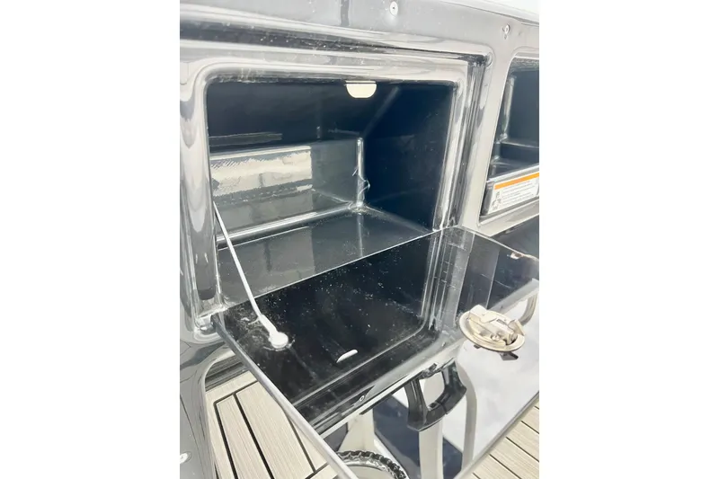 Slide: The Image of Open storage compartment on 2022 Yamaha Boats 255 FSH Sport H. - 68