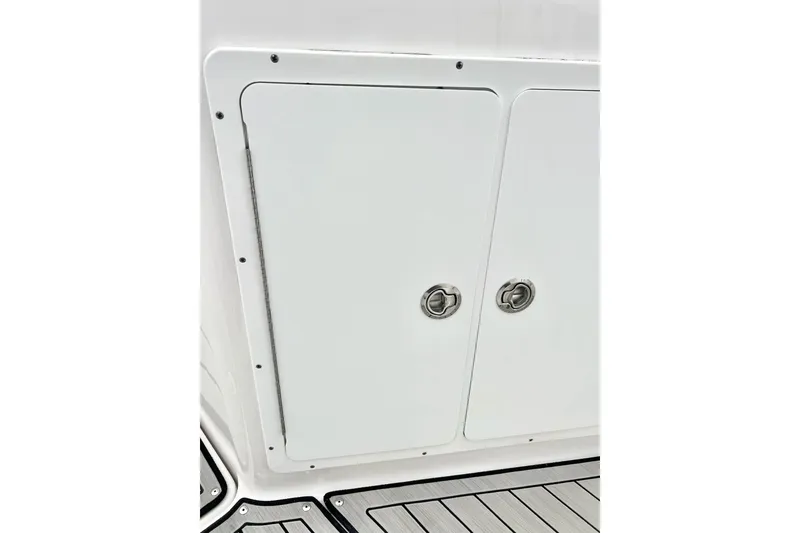 Slide: The Image of 2022 Yamaha Boats 255 FSH Sport H storage compartment with sleek design and secure latches. - 81