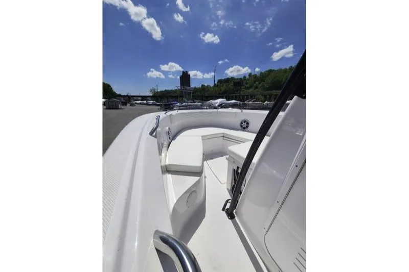 Slide: The Image of 2024 Aquasport 2100 Center Console boat under a clear blue sky. - 4