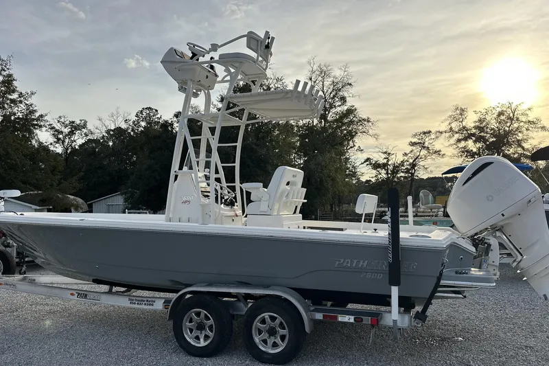 Slide: The Image of 2020 Pathfinder 2600 HPS boat on trailer, parked outdoors at sunset. - 1