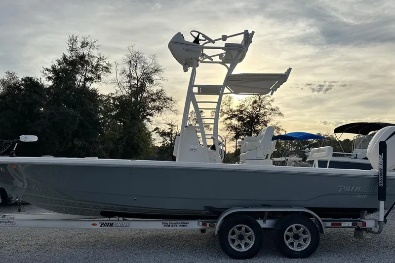 Slide: The Image of 2020 Pathfinder 2600 HPS boat on trailer, parked outdoors at sunset. - 11