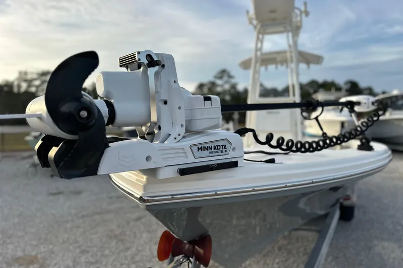 Slide: The Image of 2020 Pathfinder 2600 HPS boat with Minn Kota trolling motor, parked on gravel. - 2