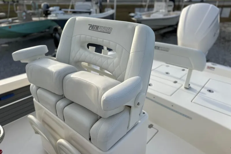 Slide: The Image of White leather captain's chair on 2020 Pathfinder 2600 HPS boat, featuring armrests and quilted design. - 21