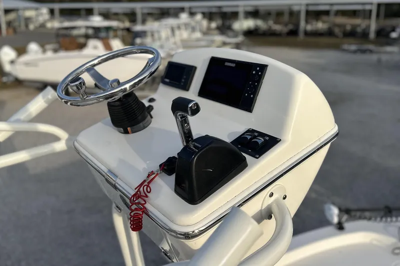 Slide: The Image of Control console of a 2020 Pathfinder 2600 HPS boat with steering wheel and throttle. - 22