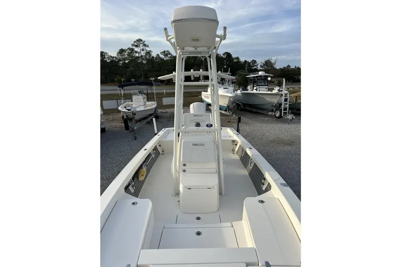 Slide: The Image of 2020 Pathfinder 2600 HPS boat, white interior, parked in a marina with other boats. - 24