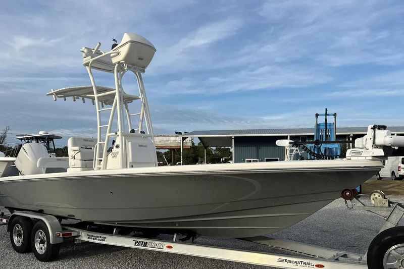 Slide: The Image of 2020 Pathfinder 2600 HPS boat on trailer, parked outdoors under blue sky. - 5