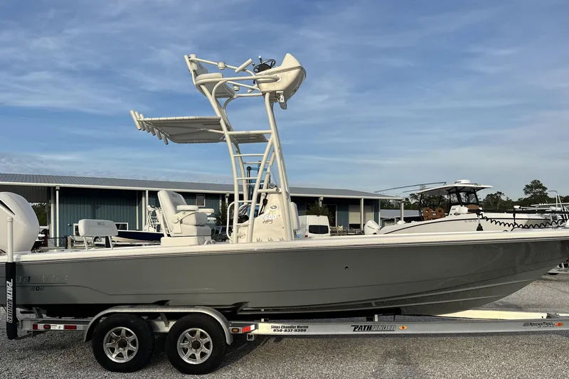Slide: The Image of 2020 Pathfinder 2600 HPS boat on trailer, parked outdoors under clear sky. - 6
