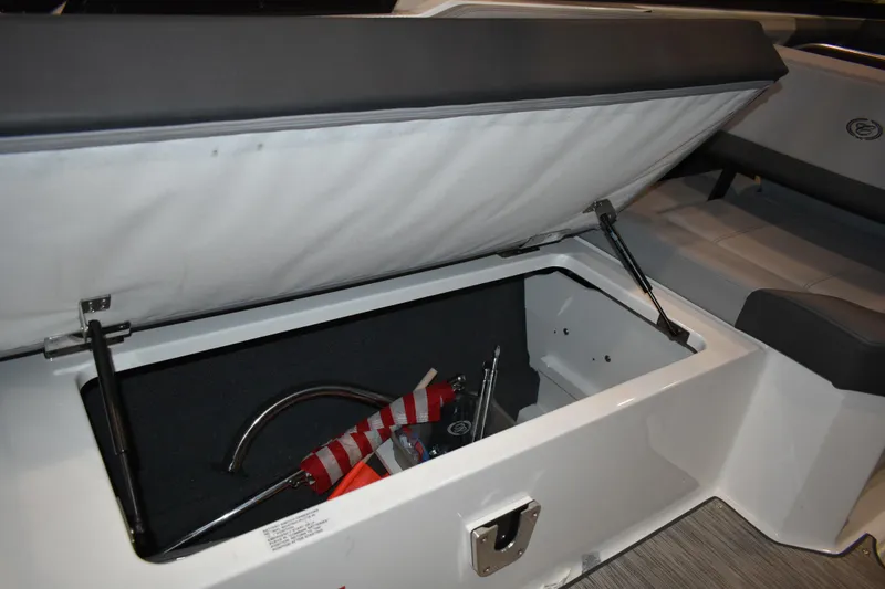 Slide: The Image of 2023 Cobalt R8 boat storage compartment with gear inside, showcasing interior design. - 24