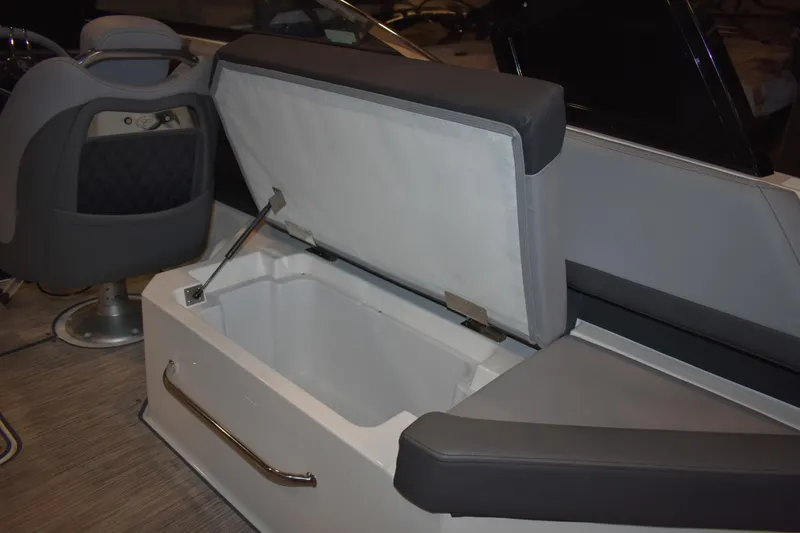 Slide: The Image of 2023 Cobalt R8 boat storage compartment with open hatch on textured flooring. - 25