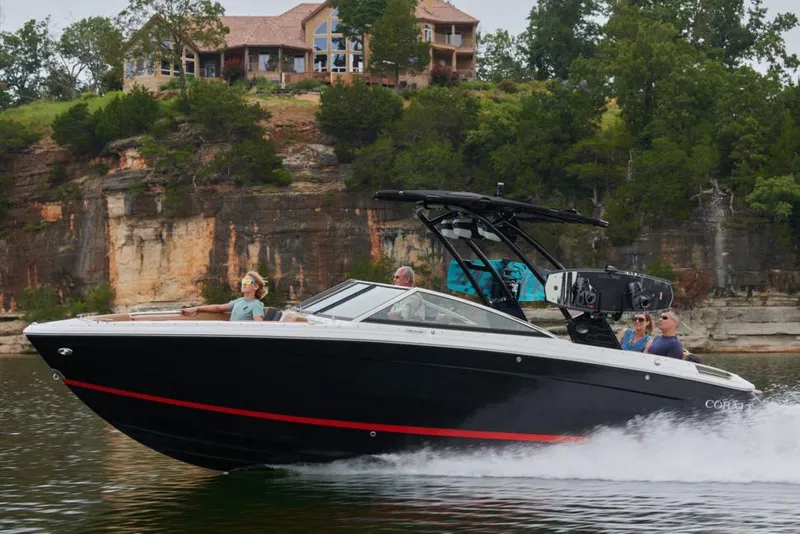 Slide: The Image of 2023 Cobalt R8 boat stern with swim platform and propeller in a garage setting. - 35