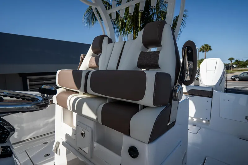 Slide: The Image of 2021 Tidewater 320 CC Adventure boat swim platform with ladder and engine detail. - 17