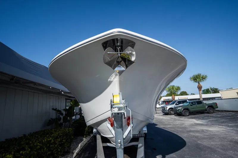 Slide: The Image of 2021 Tidewater 320 CC Adventure boat docked in calm waters. - 2