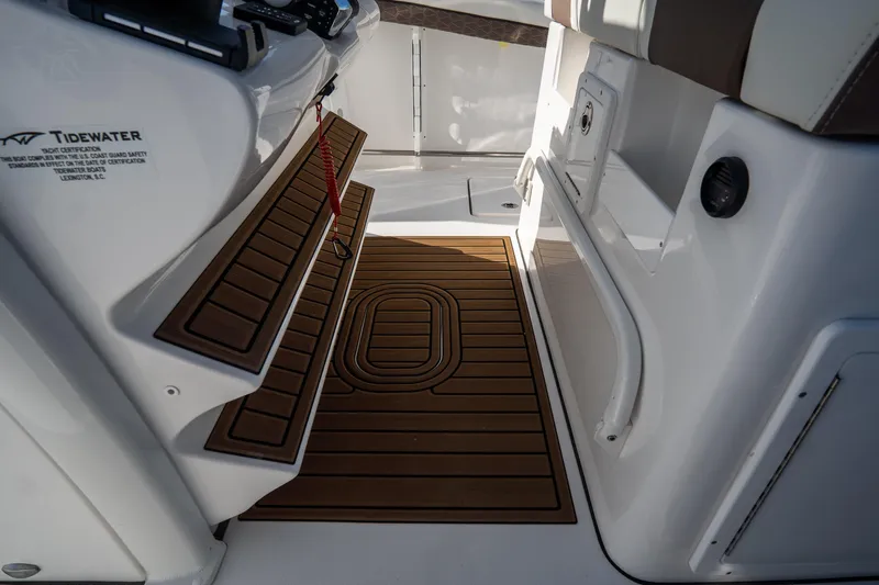 Slide: The Image of 2021 Tidewater 320 CC Adventure boat interior detail with white cushioned seating. - 21