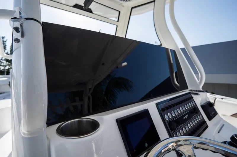 Slide: The Image of 2021 Tidewater 320 CC Adventure boat interior with helm and seating area. - 24