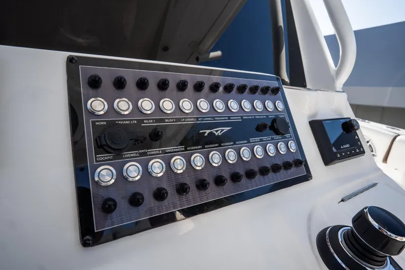 Slide: The Image of 2021 Tidewater 320 CC Adventure boat interior with luxurious seating and steering wheel. - 25