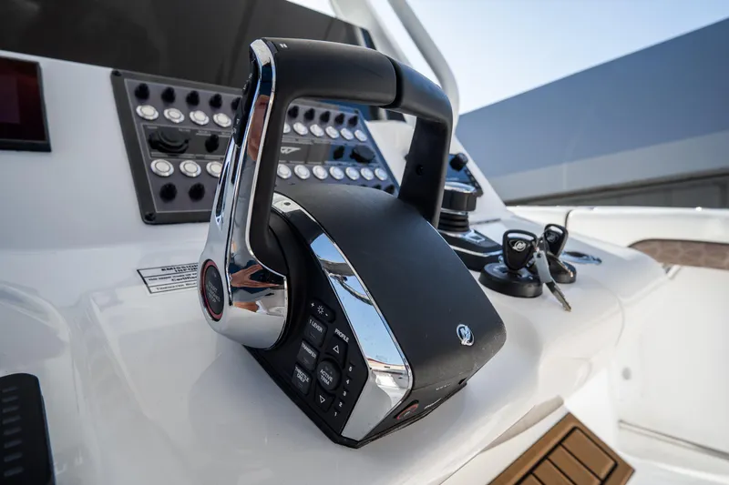 Slide: The Image of Luxury seating on 2021 Tidewater 320 CC Adventure boat, docked in a scenic marina. - 26