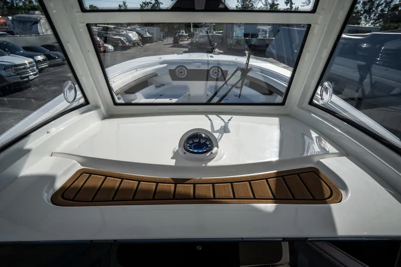 Slide: The Image of 2021 Tidewater 320 CC Adventure boat console with steering wheel and controls. - 29