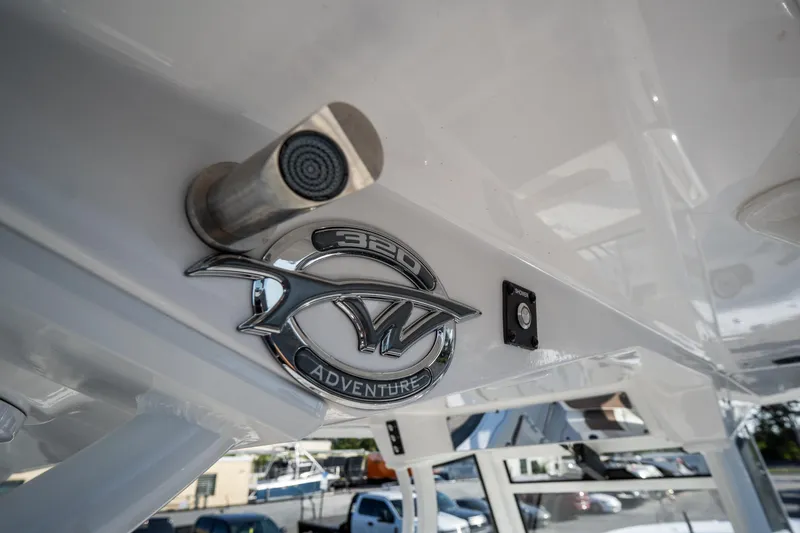 Slide: The Image of 2021 Tidewater 320 CC Adventure boat interior with cushioned seating and speakers. - 37