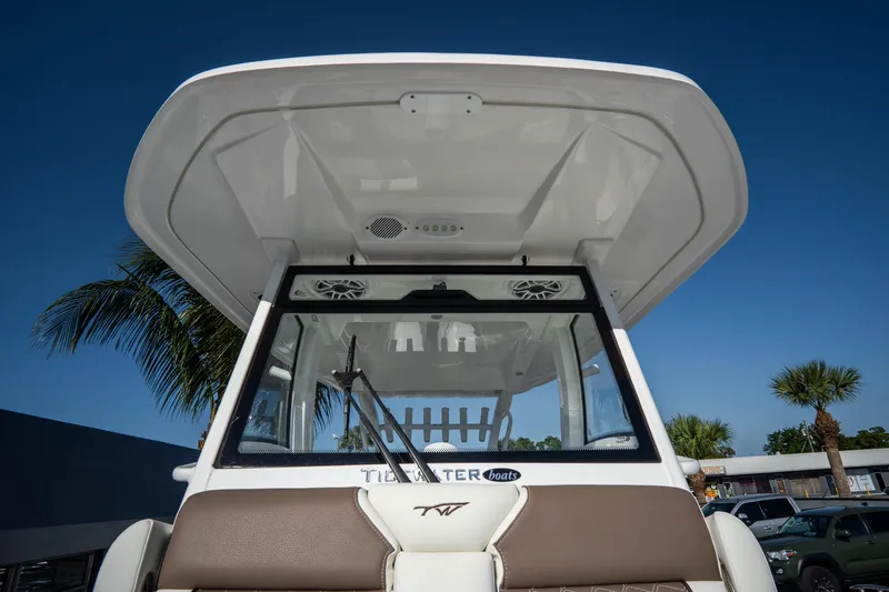 Slide: The Image of 2021 Tidewater 320 CC Adventure boat docked, showcasing spacious seating and sleek design. - 40