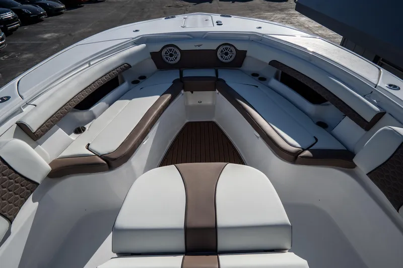 Slide: The Image of 2021 Tidewater 320 CC Adventure boat interior with open storage compartments and speakers. - 41