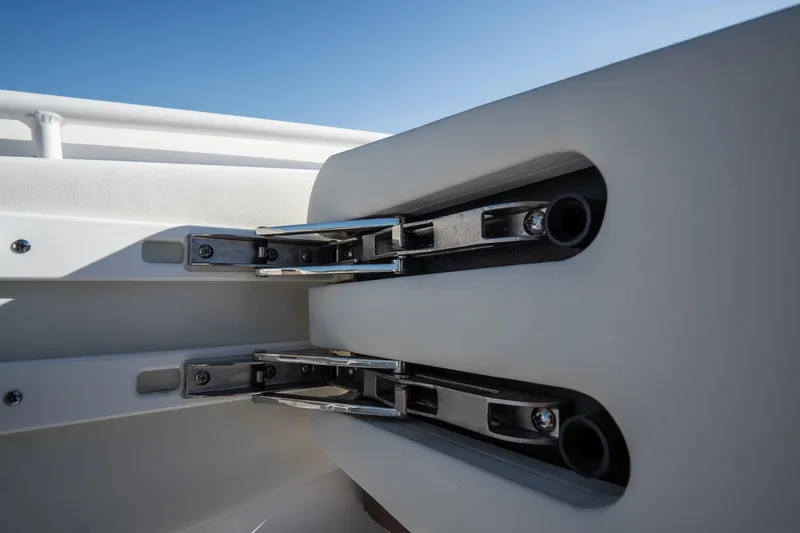 Slide: The Image of 2021 Tidewater 320 CC Adventure boat interior with cup holders and storage compartment. - 47