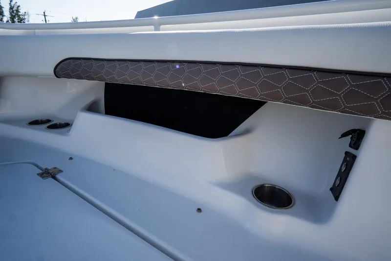 Slide: The Image of 2021 Tidewater 320 CC Adventure boat interior with cushioned seating and speakers. - 51