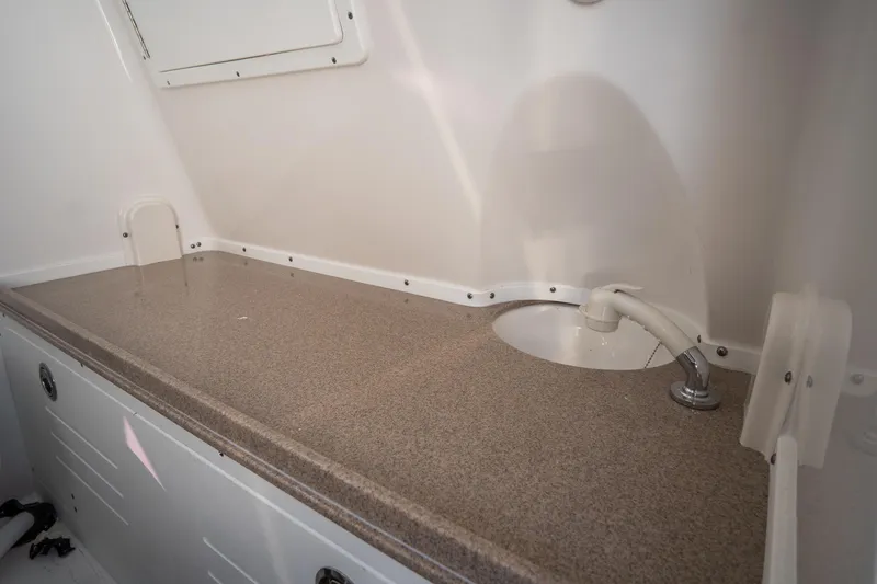 Slide: The Image of 2021 Tidewater 320 CC Adventure boat interior with sink and countertop. - 62
