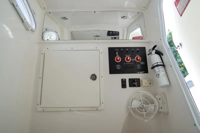 Slide: The Image of Control panel and safety equipment inside 2021 Tidewater 320 CC Adventure boat cabin. - 63