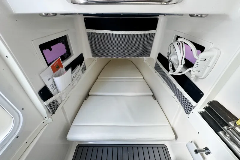 Slide: The Image of 2021 Tidewater 320 CC Adventure cabin interior with white cushions and storage compartments. - 65