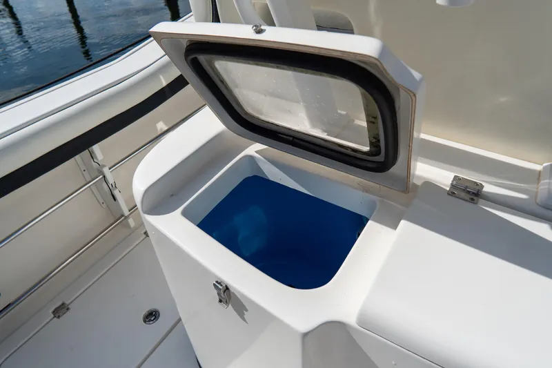 Slide: The Image of Open storage compartment on 2021 Tidewater 320 CC Adventure boat. - 68