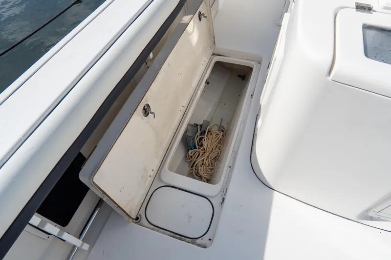 Slide: The Image of Open storage compartment on 2021 Tidewater 320 CC Adventure boat with rope inside. - 69