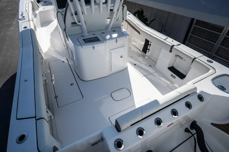 Slide: The Image of 2021 Tidewater 320 CC Adventure boat docked in a scenic marina setting. - 7