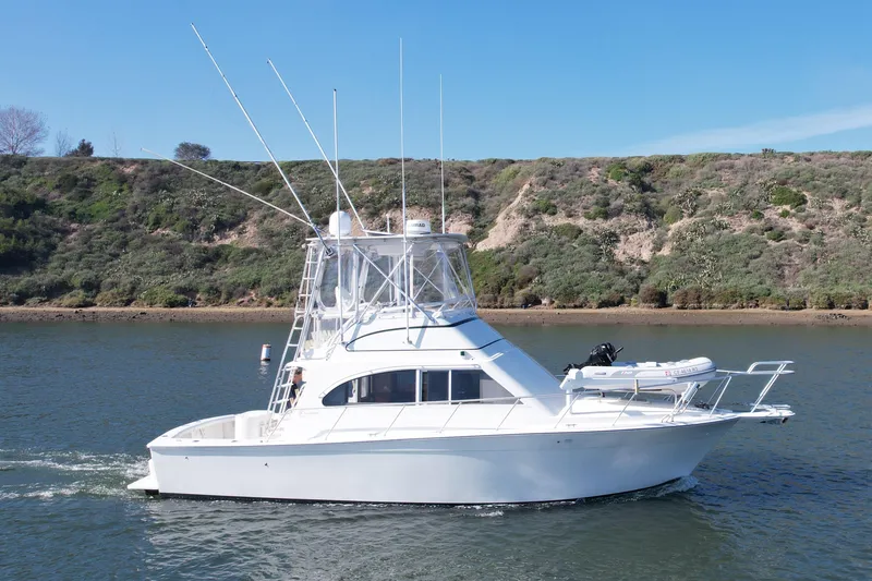 Slide: The Image of 1996 Egg Harbor 35 Sport Fisherman boat cruising on a scenic waterway. - 10