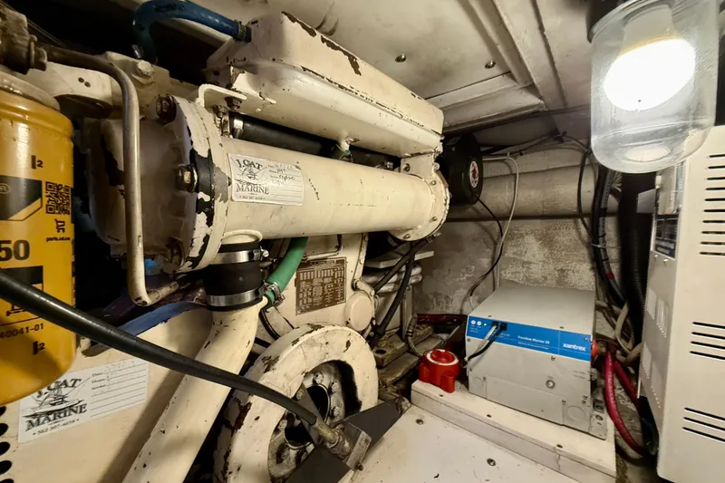 Slide: The Image of Engine room of a 1996 Egg Harbor 35 Sport Fisherman boat, featuring mechanical components. - 17