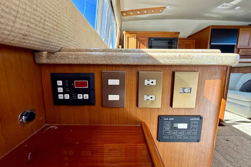 Slide: The Image of 1996 Egg Harbor 35 Sport Fisherman interior control panel with switches and outlets. - 23