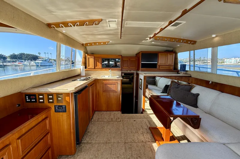 Slide: The Image of Luxurious interior of a 1996 Egg Harbor 35 Sport Fisherman yacht with wood cabinetry and seating. - 24